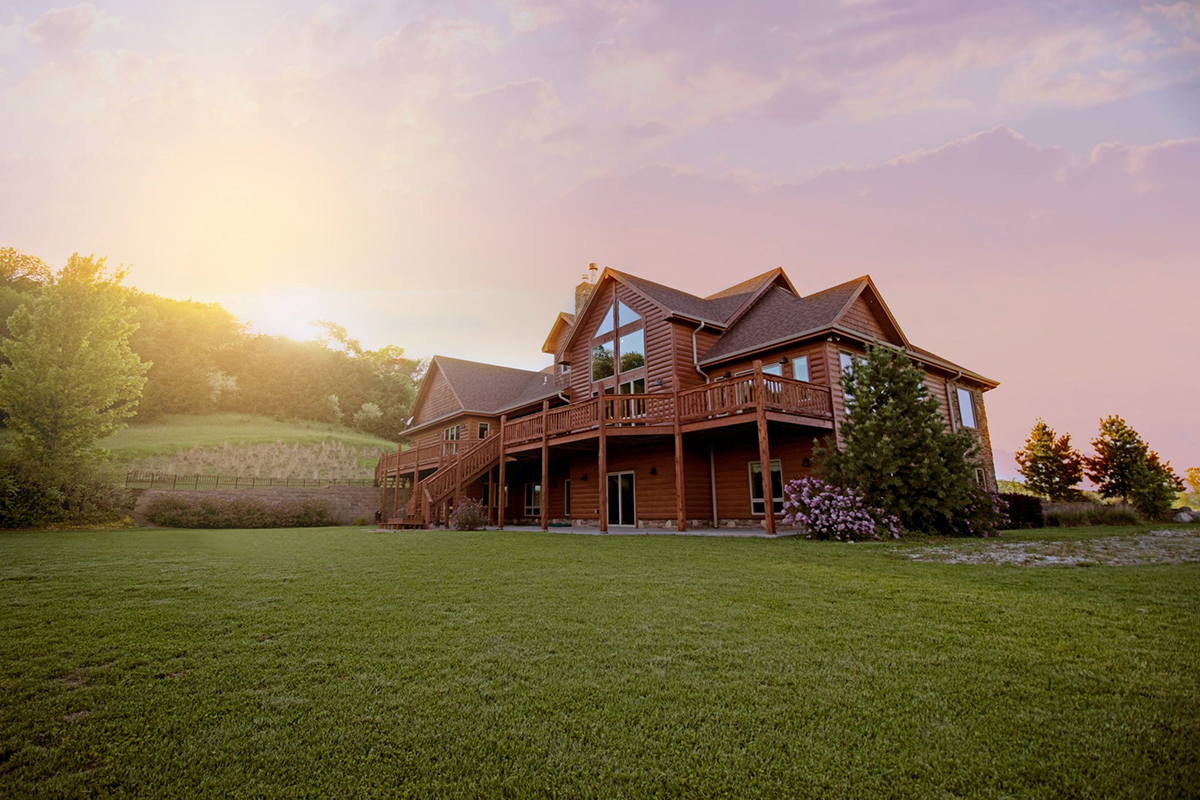 Vacation cabin rental on hill with sunset in the background