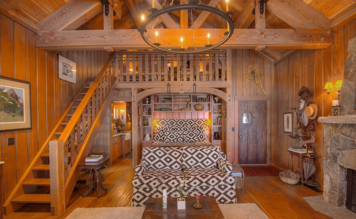 View of a couch and chandelier inside a cabin