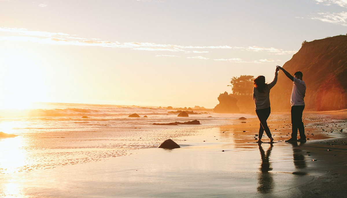 Couple on beach during an affordable vacation in san diego, california