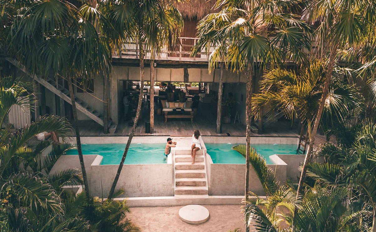 A couple stands together by the pool at a last minute vacation resort in Florida