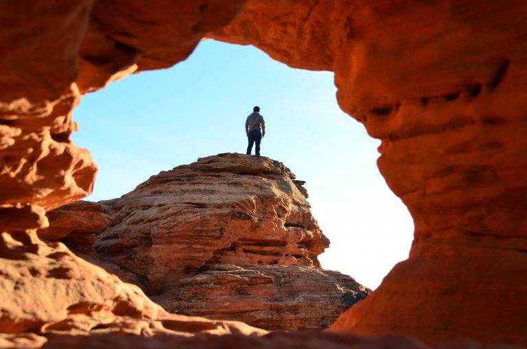 View through a sandstone arch in St. George Utah - the perfect getaway for a Spring Break vacation.