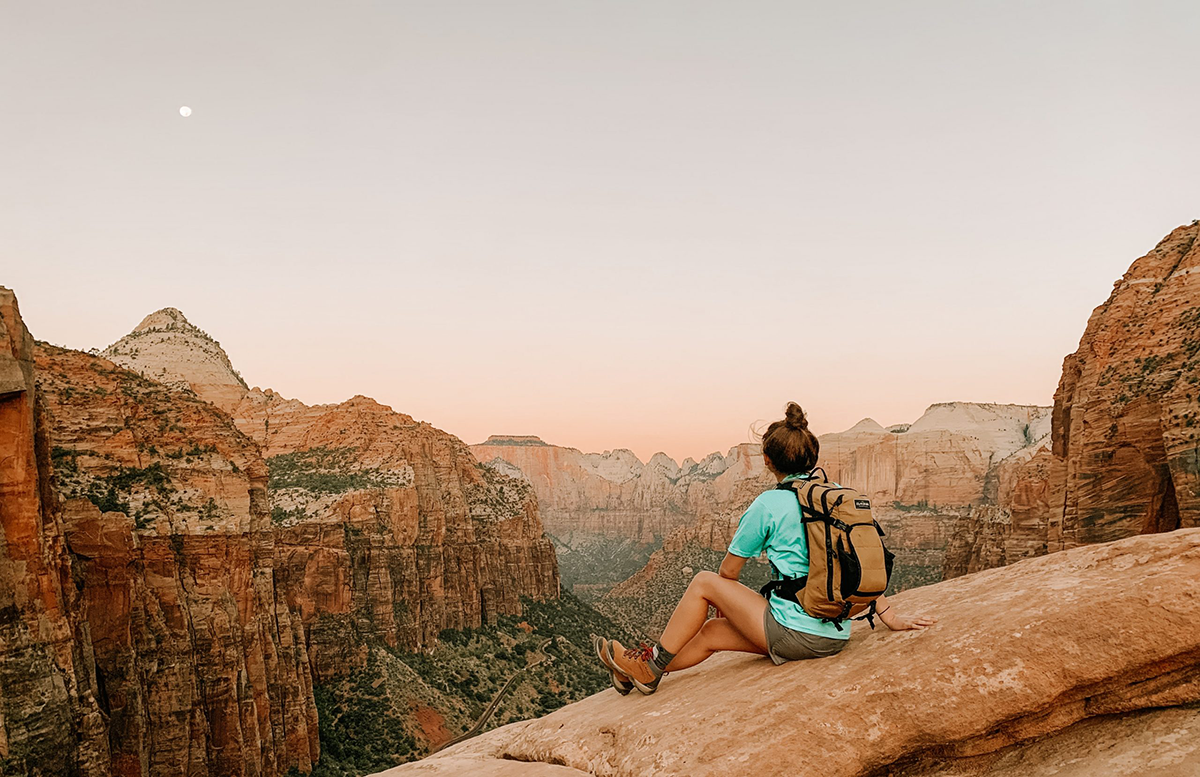 Woman looks out at Zion Canyon during a trip to St. George, Utah on a last minute vacation