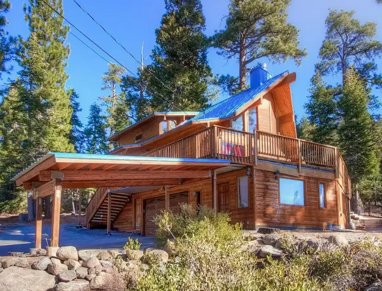 Vacation cabin rental with log cabin structure and large deck along with a-frame roof