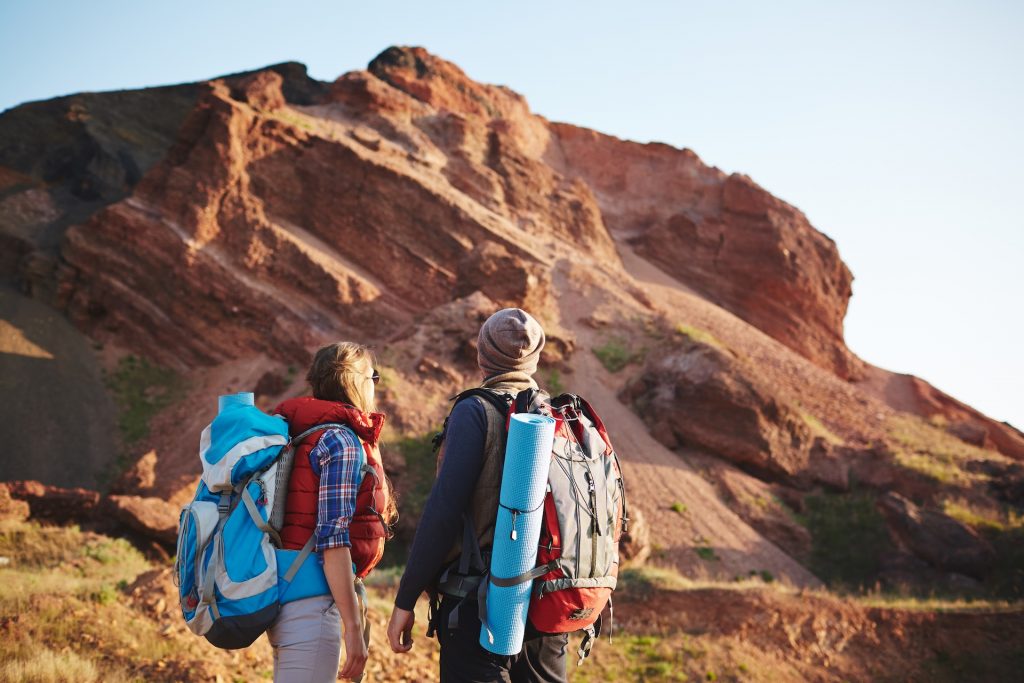 A couple looking at a mountain top on hiking path in Sedona.