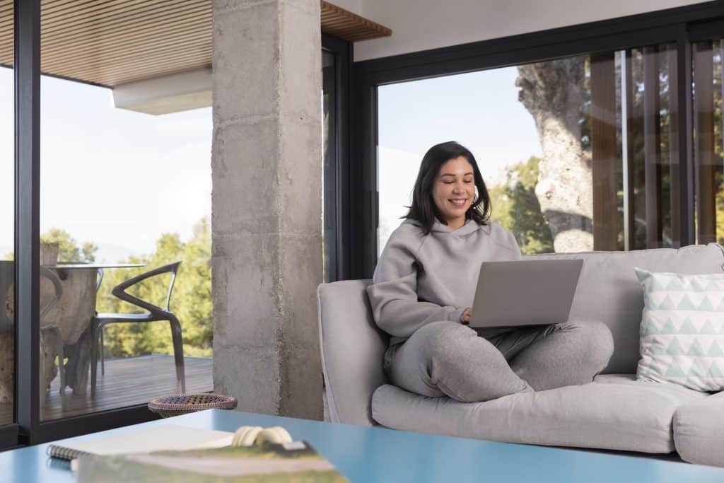 Woman working remotely with a gorgeous view from her balcony.