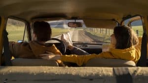 A couple in a car during a roadtrip.