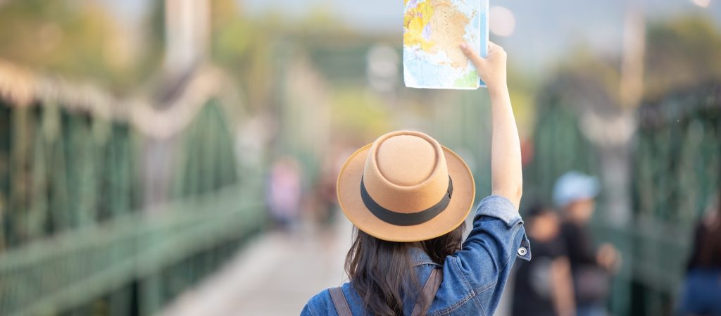 Woman holding map while traveling.