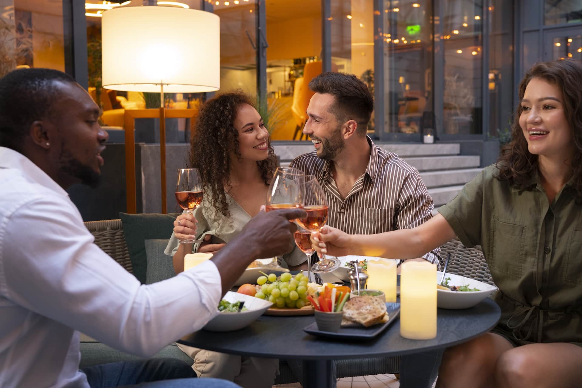 Friends gather around a dinner table.