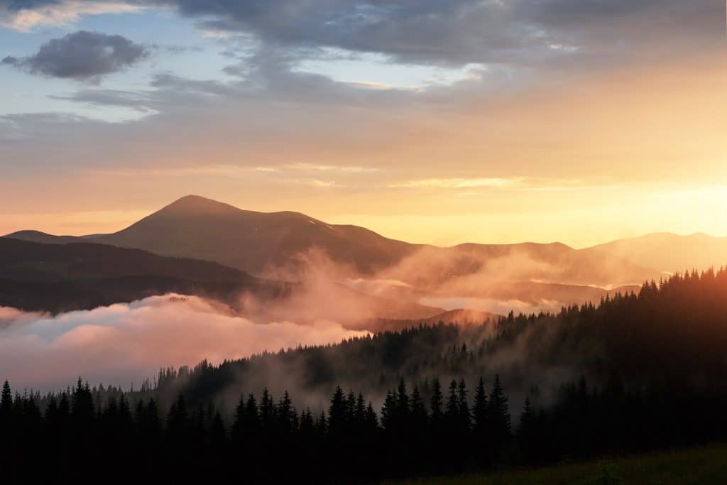 Fog over mountains at sunrise.