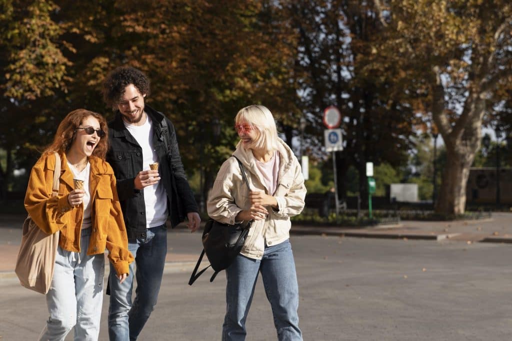 Friends walking down a street together.