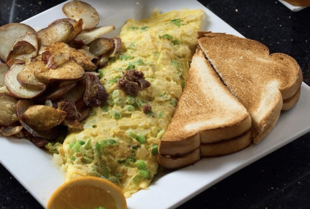 Scrambled eggs with toast and potatoes