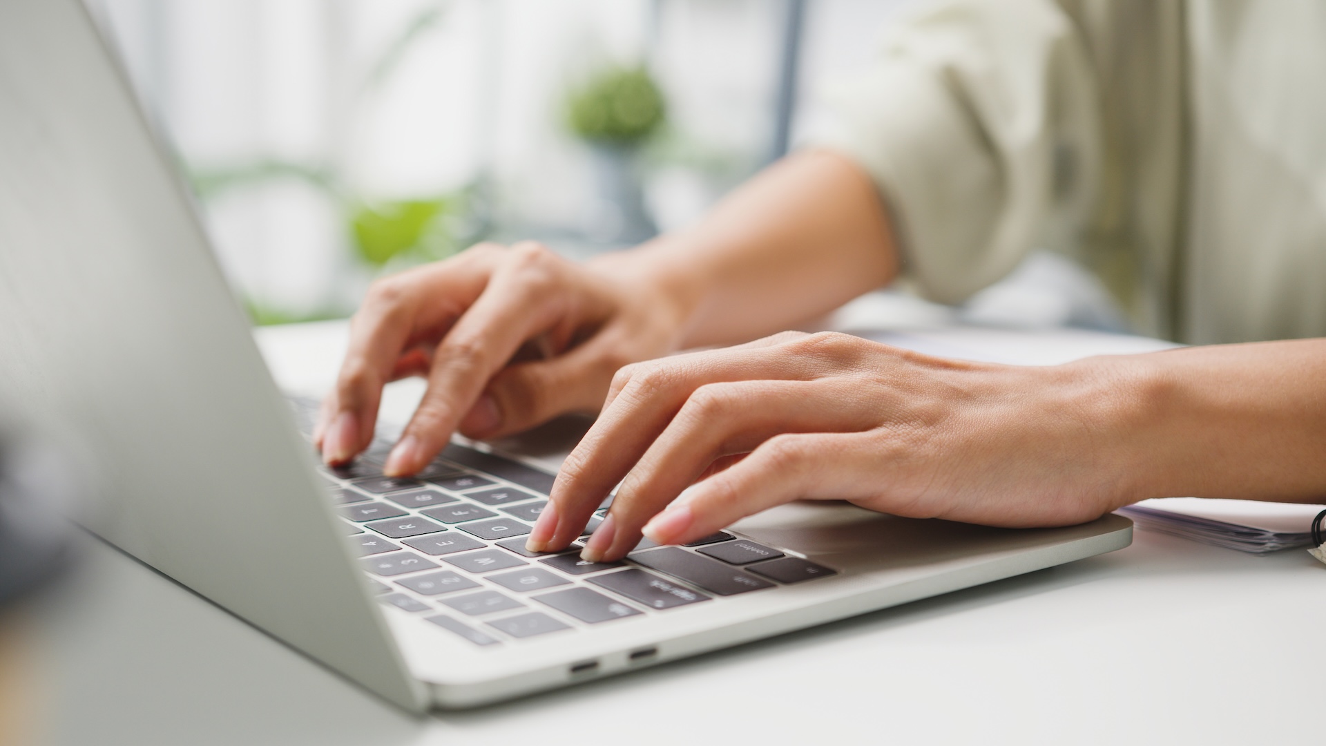 hands typing on a laptop
