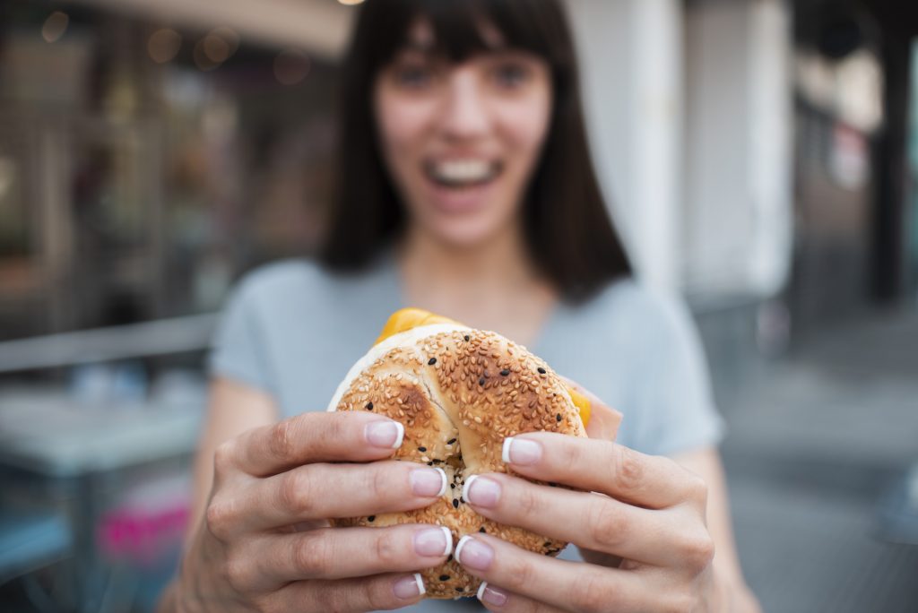 woman eating a bagel