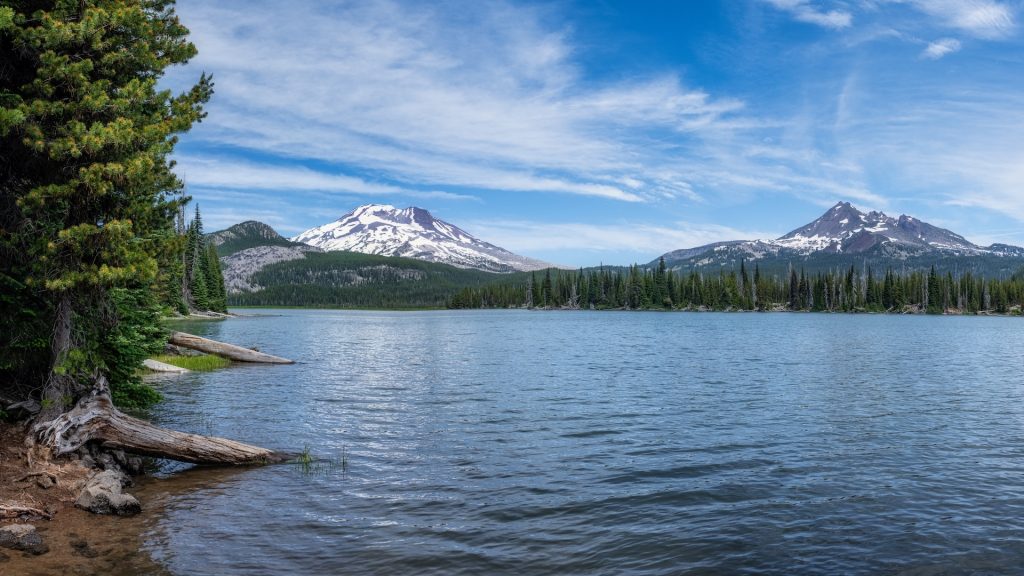 Water sits in front of a mountainscape.