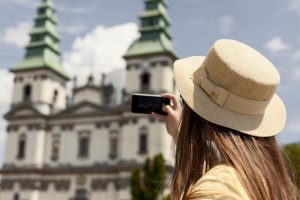 Woman taking a selfie in front of a monument.