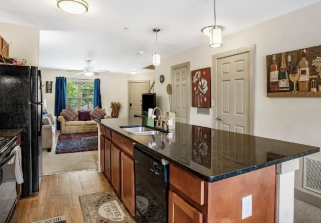 A kitchen with black marble countertops.