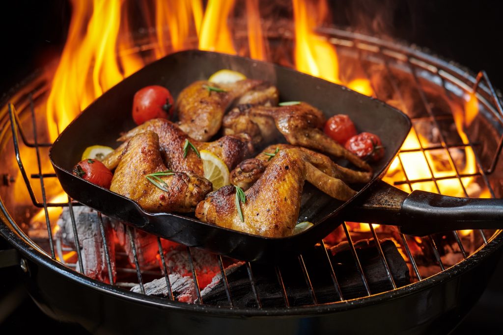 Chicken and vegetables cooking on a grill